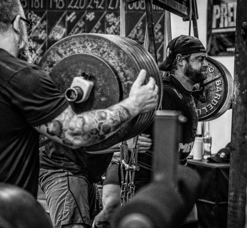 Lifter training with a loaded bar at Elite Fitness