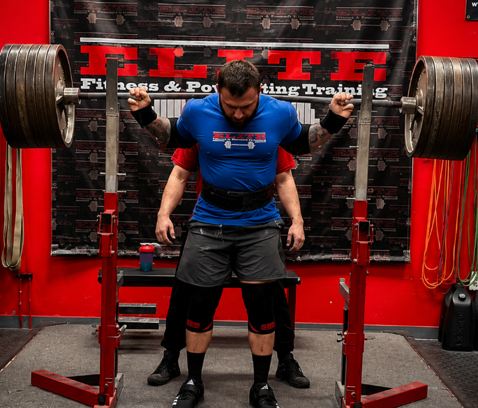 Lifter squatting at Elite Fitness